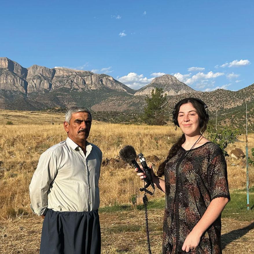 Rose Gilbert conducting an interview with a man in the village of Chalke in Iraqi-Kurdistan